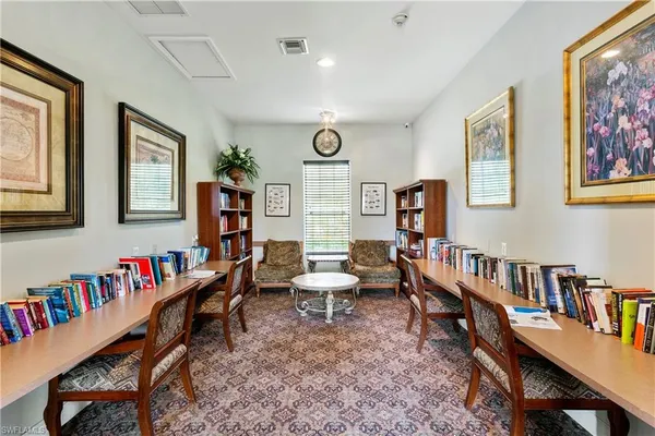 a living room with furniture and a book shelf