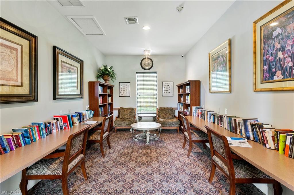 Undisclosed Address Naples, FL 34112 - Photo 21 of 23 a living room with furniture and a book shelf