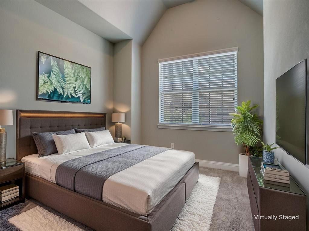 6120 Rilla Street Frisco, TX 75035 - Photo 16 of 20 a bedroom with a large bed and a flat screen tv