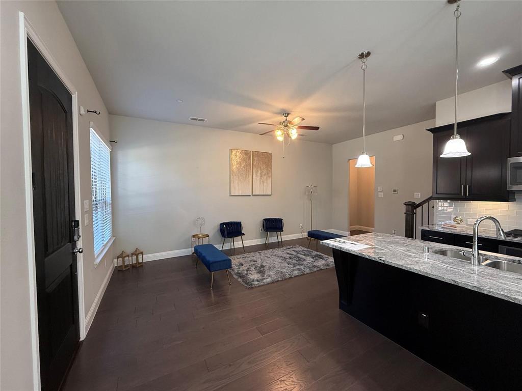 6120 Rilla Street Frisco, TX 75035 - Photo 5 of 20 a large kitchen with a counter space a sink appliances and living room