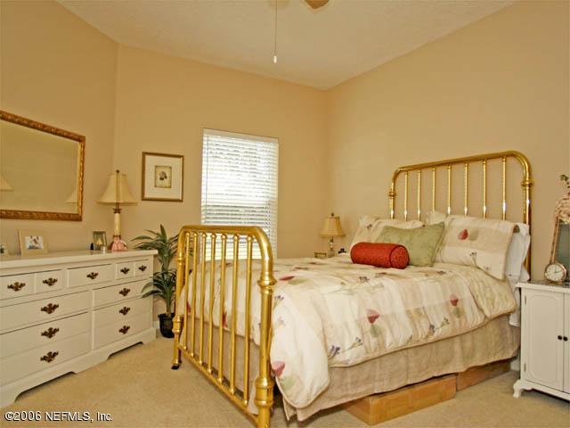 10027 Deercreek Club Road Jacksonville, FL 32256 - Photo 12 of 15 a bedroom with a bed and a dresser