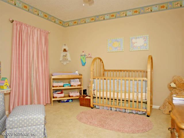10027 Deercreek Club Road Jacksonville, FL 32256 - Photo 13 of 15 a view of a bedroom with a window and walk in closet