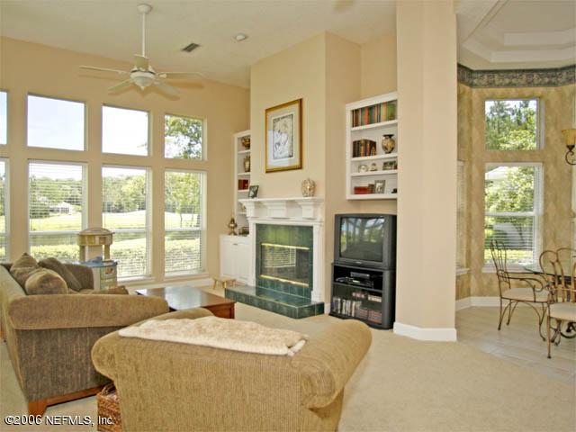 10027 Deercreek Club Road Jacksonville, FL 32256 - Photo 3 of 15 a bedroom with a large bed and a large window