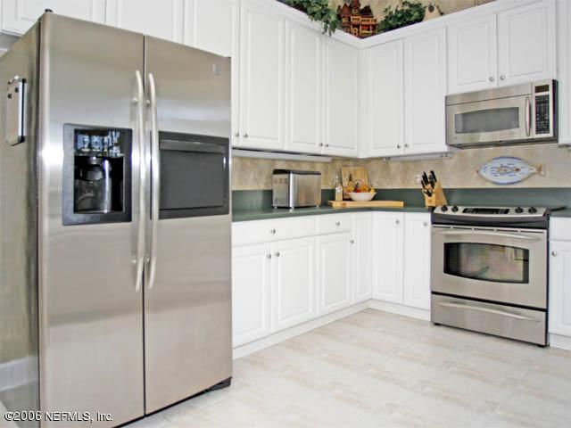 10027 Deercreek Club Road Jacksonville, FL 32256 - Photo 5 of 15 a kitchen with cabinets stainless steel appliances and sink