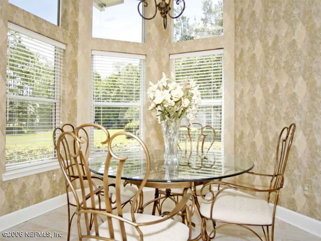 10027 Deercreek Club Road Jacksonville, FL 32256 - Photo 6 of 15 a dining room with furniture and large windows