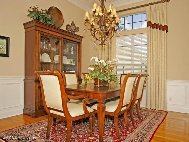 10027 Deercreek Club Road Jacksonville, FL 32256 - Photo 7 of 15 a view of a dining room with furniture and wooden floor