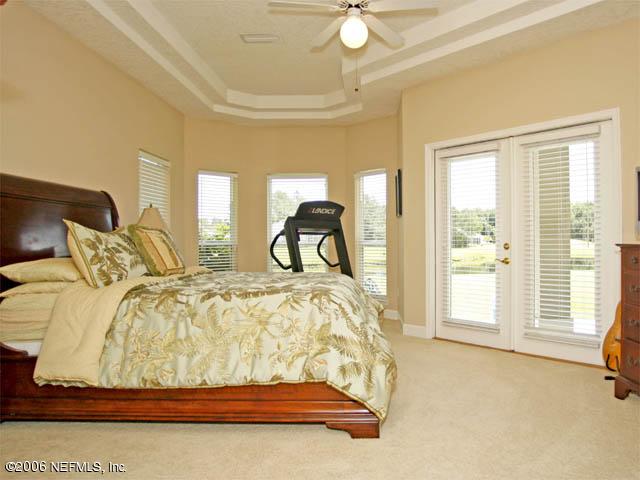 10027 Deercreek Club Road Jacksonville, FL 32256 - Photo 9 of 15 a bed sitting in a bedroom next to a window