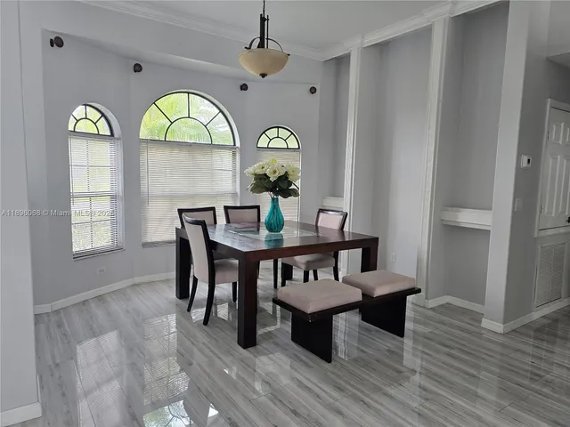 a view of a dining room with furniture window and wooden floor