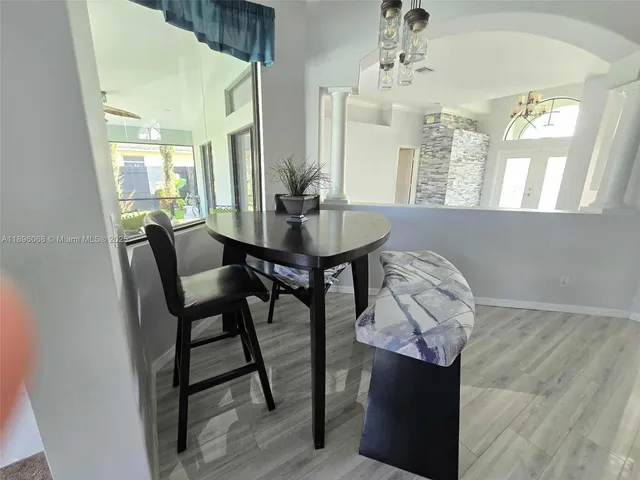 a view of a dining room with furniture and a chandelier