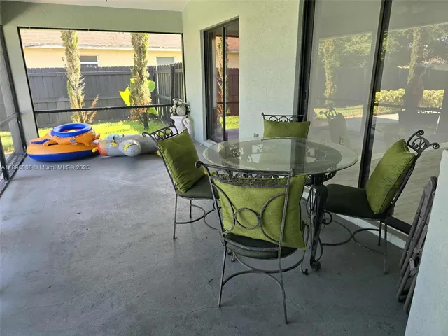 a view of a dining room with furniture and a window