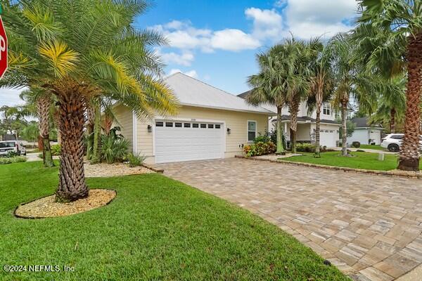 a front view of a house with a yard garage and fountain