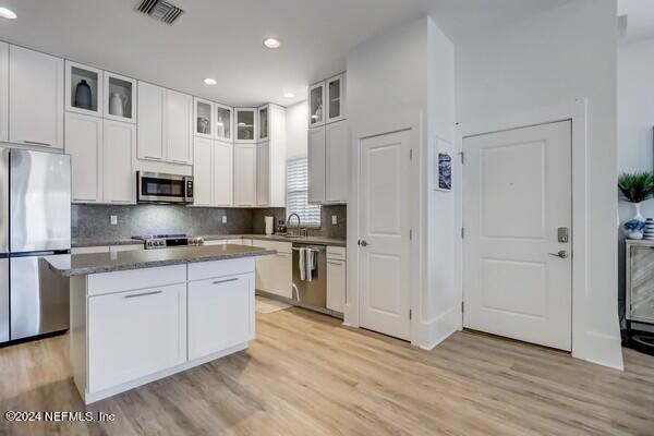3081 Pullian Court Jacksonville Beach, FL 32250 - Photo 11 of 56 a large kitchen with cabinets wooden floor and stainless steel appliances