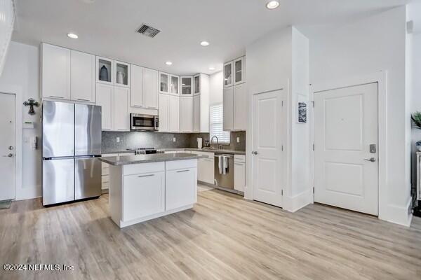 3081 Pullian Court Jacksonville Beach, FL 32250 - Photo 12 of 56 a kitchen with white cabinets and stainless steel appliances