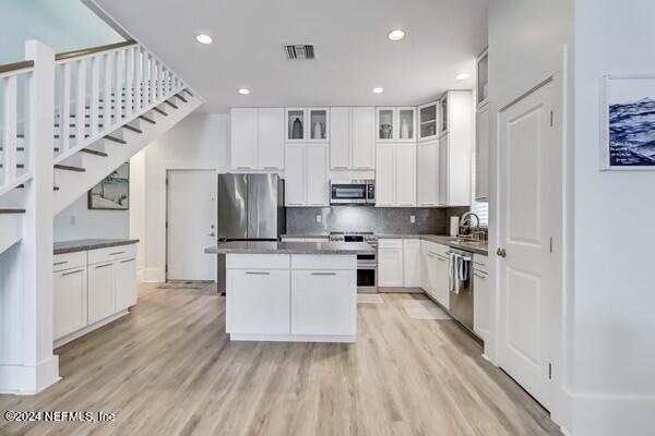 3081 Pullian Court Jacksonville Beach, FL 32250 - Photo 13 of 56 a kitchen with white cabinets and stainless steel appliances