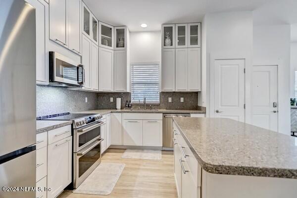 3081 Pullian Court Jacksonville Beach, FL 32250 - Photo 16 of 56 a kitchen with stainless steel appliances granite countertop a stove a sink and a microwave