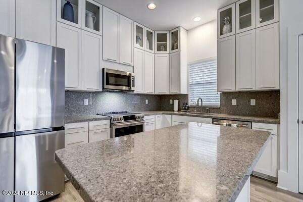 3081 Pullian Court Jacksonville Beach, FL 32250 - Photo 17 of 56 a kitchen with stainless steel appliances granite countertop a stove a sink a refrigerator a microwave and cabinets