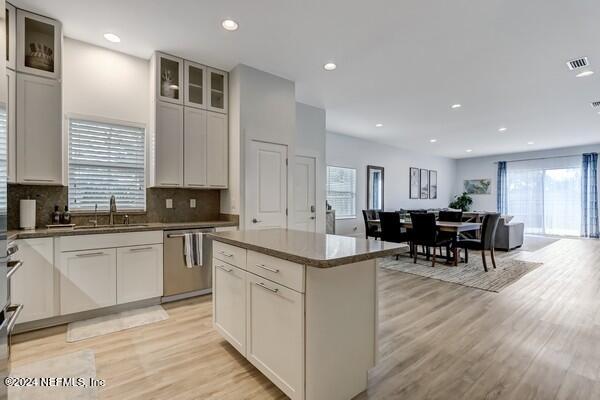 3081 Pullian Court Jacksonville Beach, FL 32250 - Photo 18 of 56 a kitchen with stainless steel appliances granite countertop dining table chairs sink and cabinets
