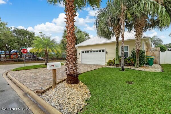 3081 Pullian Court Jacksonville Beach, FL 32250 - Photo 2 of 56 a front view of a house with garden and trees