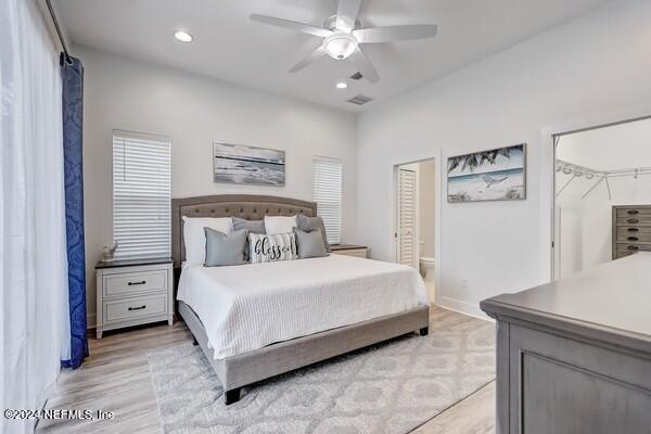 3081 Pullian Court Jacksonville Beach, FL 32250 - Photo 25 of 56 a bedroom with a bed and a chandelier