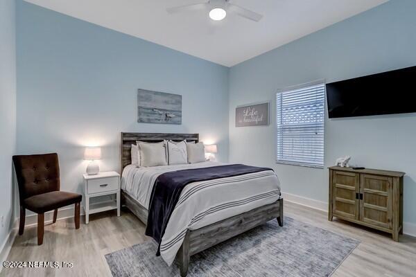 3081 Pullian Court Jacksonville Beach, FL 32250 - Photo 32 of 56 a bedroom with a bed a couch and a television