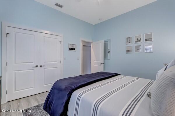 3081 Pullian Court Jacksonville Beach, FL 32250 - Photo 33 of 56 a bedroom with a bed and cabinets