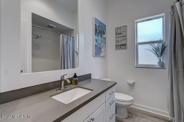 3081 Pullian Court Jacksonville Beach, FL 32250 - Photo 34 of 56 a bathroom with a granite countertop sink mirror vanity and toilet