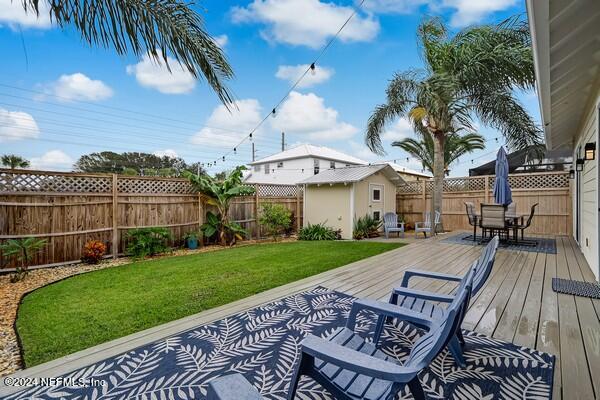 3081 Pullian Court Jacksonville Beach, FL 32250 - Photo 55 of 56 a view of a patio with table and chairs with wooden floor and fence