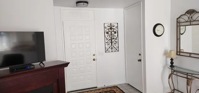 a room with a flat screen tv and a wall painting