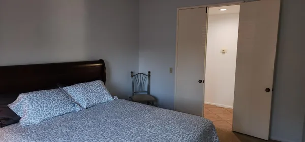 a bedroom with a bed and a mirror