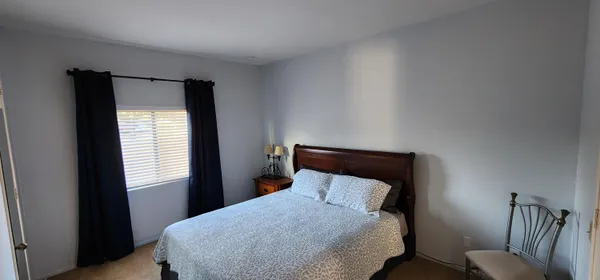 a bedroom with a bed and window