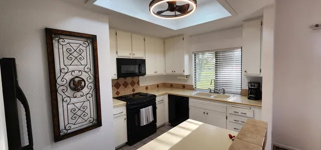 a kitchen with a sink cabinets and window