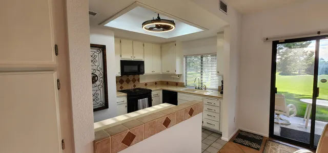 a kitchen with a stove a sink and a refrigerator