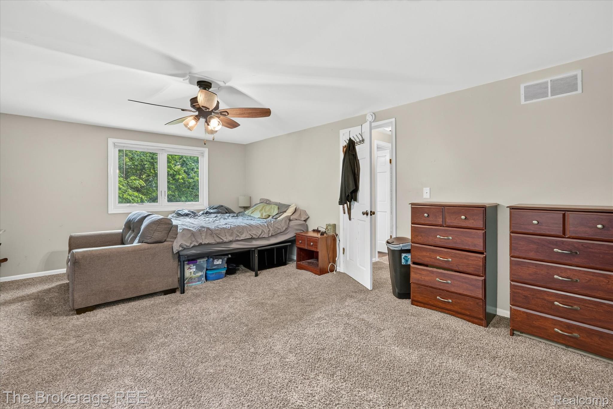 13269 North Genesee Road Clio, MI 48420 - Photo 29 of 67 Carpeted room with a ceiling fan light fixture, white trim window, and neutral wall paint