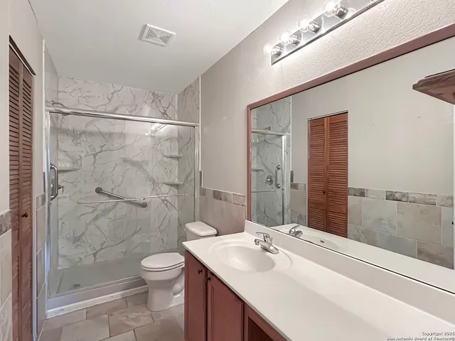 a bathroom with a sink toilet and shower