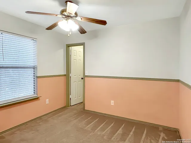 a view of a room with a ceiling fan