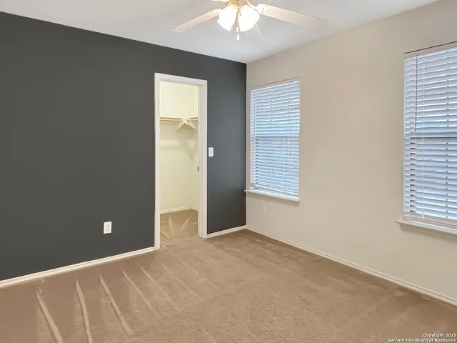 an empty room with windows and closet
