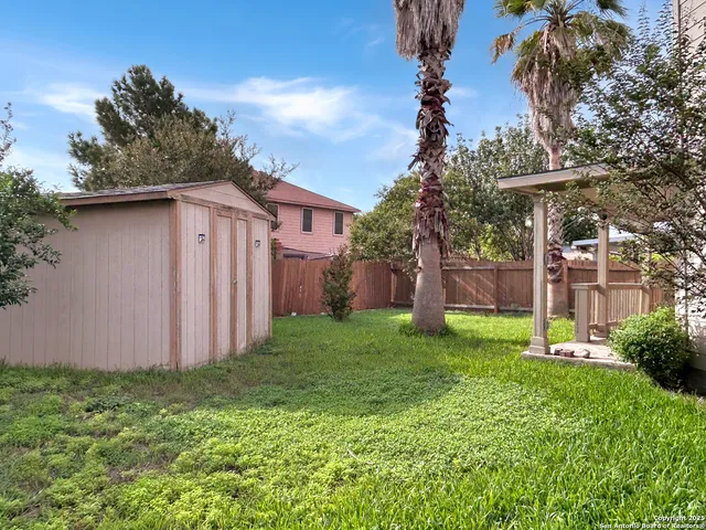 a view of a backyard with potted plants