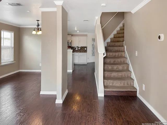 a view of entryway and hall with wooden floor