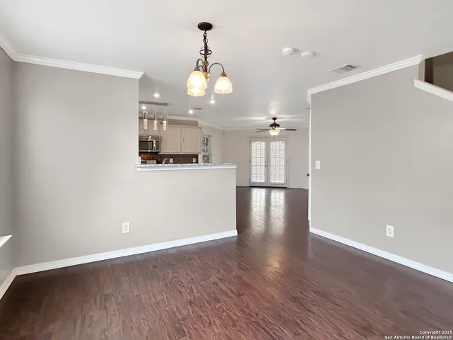 a view of a kitchen with a sink wooden floor and a refrigerator