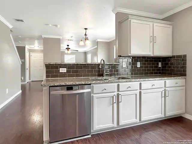 a kitchen with stainless steel appliances granite countertop a sink stove and cabinets