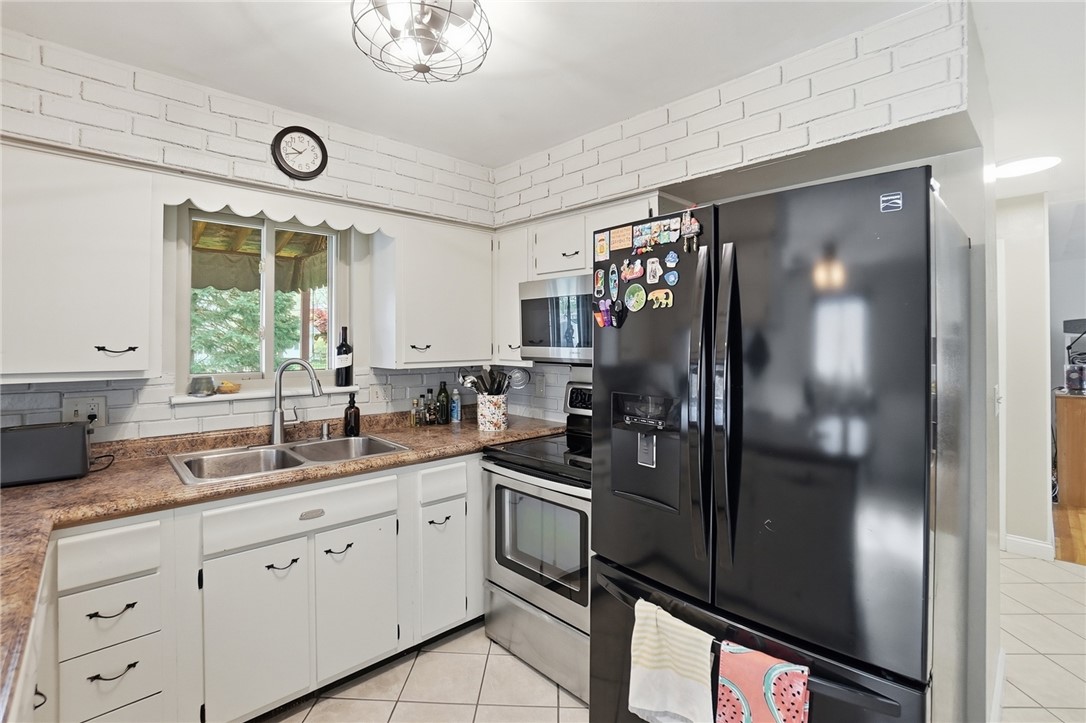 150 Littlejohn Road Troy, OH 45373 - Photo 13 of 40 This kitchen boasts ample cabinet space and modern appliances for culinary ease.