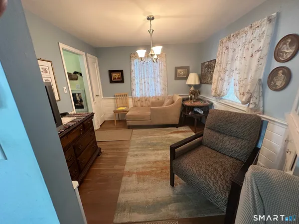 a kitchen with stainless steel appliances granite countertop a stove a sink a dining table and chairs