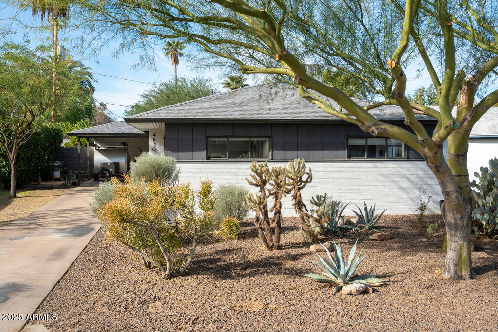 a front view of a house with garden