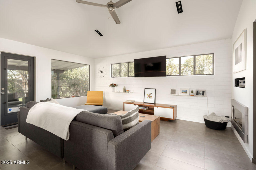 4530 North 9th Avenue Phoenix, AZ 85013 - Photo 16 of 35 a bedroom with a bed a flat screen tv and a couch