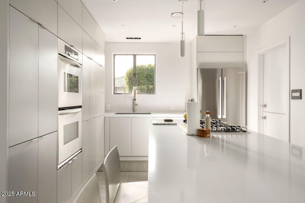 4530 North 9th Avenue Phoenix, AZ 85013 - Photo 6 of 35 a kitchen with stainless steel appliances a refrigerator and a stove