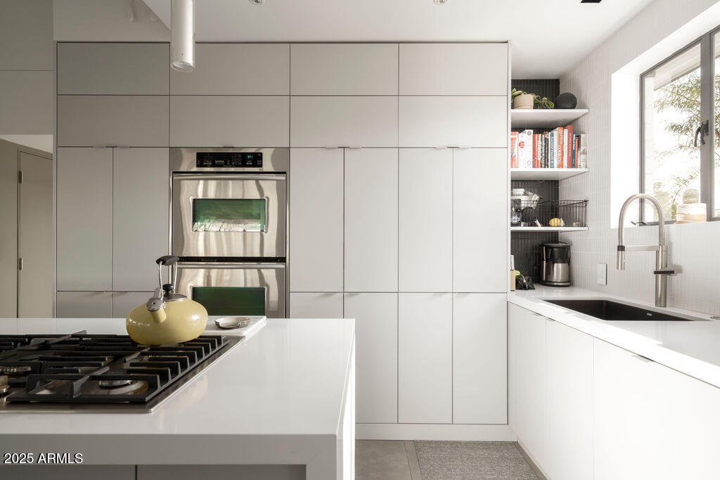 4530 North 9th Avenue Phoenix, AZ 85013 - Photo 7 of 35 a kitchen with a sink appliances and cabinets