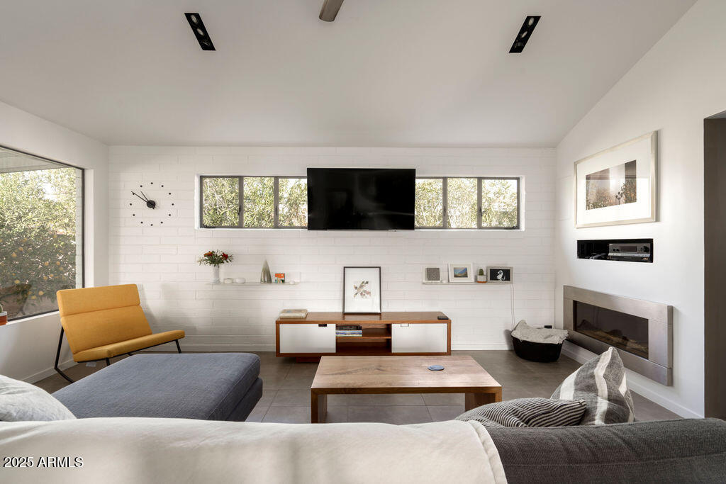 4530 North 9th Avenue Phoenix, AZ 85013 - Photo 10 of 35 a living room with furniture and a flat screen tv