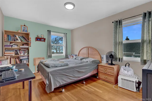 a bedroom with a bed and a large window