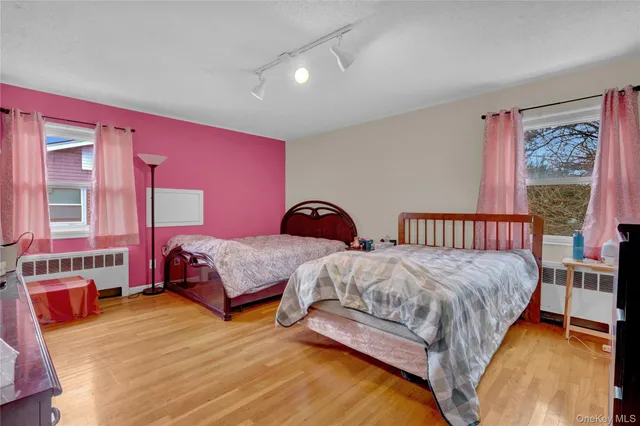 a bedroom with two beds and window