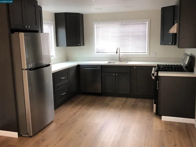 a kitchen with a refrigerator and a sink